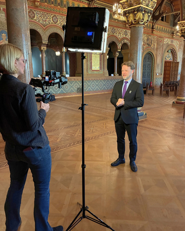 in dem großen Saal gibt Finanzminister Heere vor einer Kamera noch ein Interview.